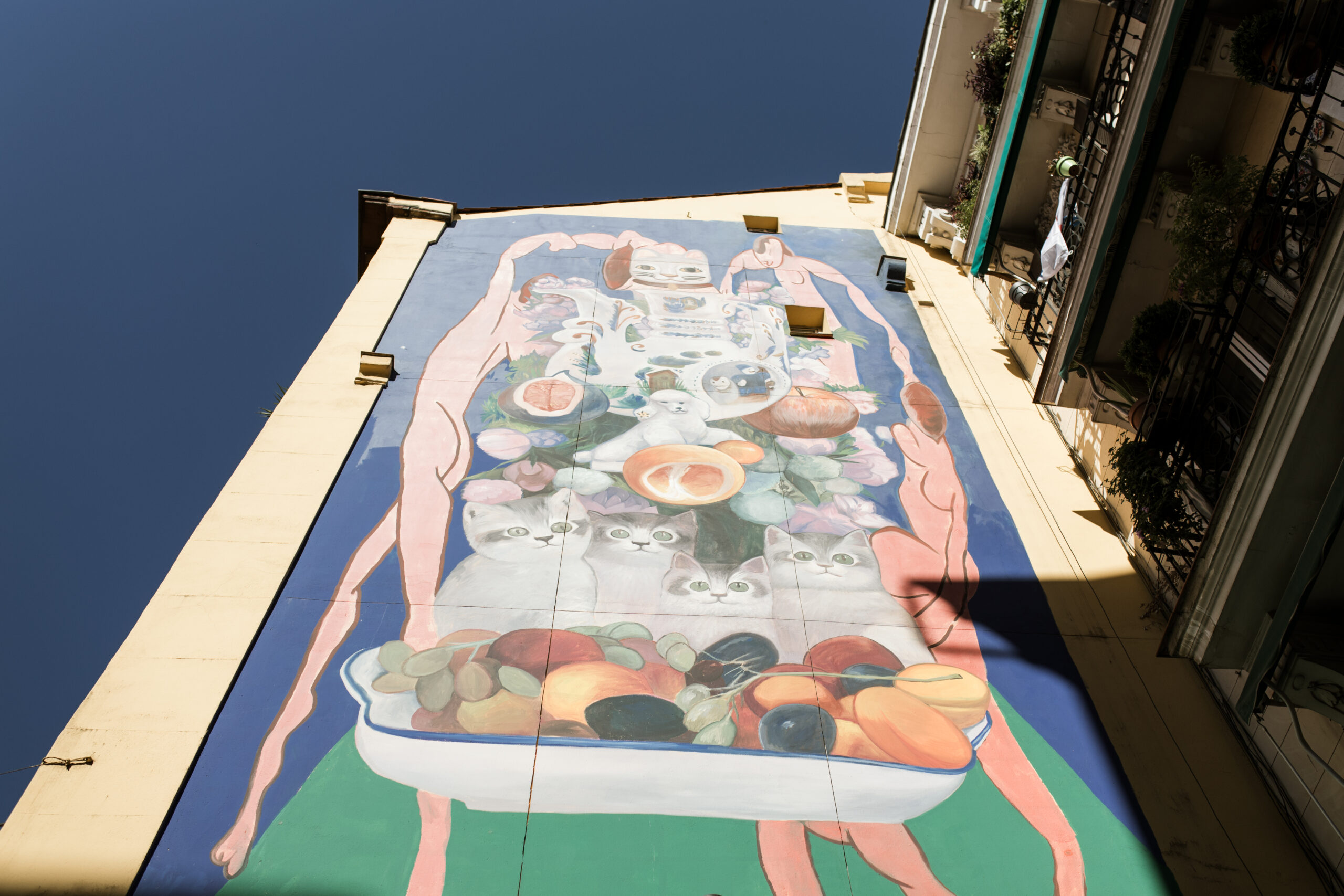 Huge colourful mural in Madrid with Matisse's 'The Dance' in the background and symbols inspired by the local neighbourhood