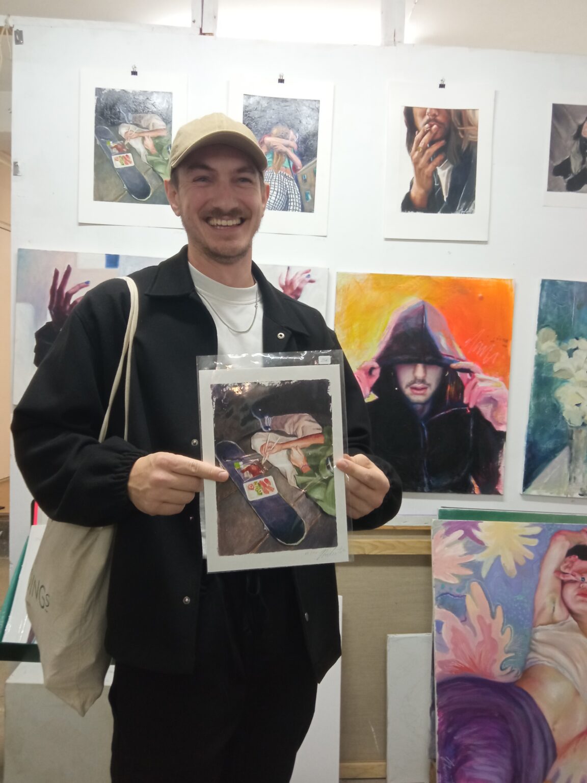 Showing off new art acquisition in studio