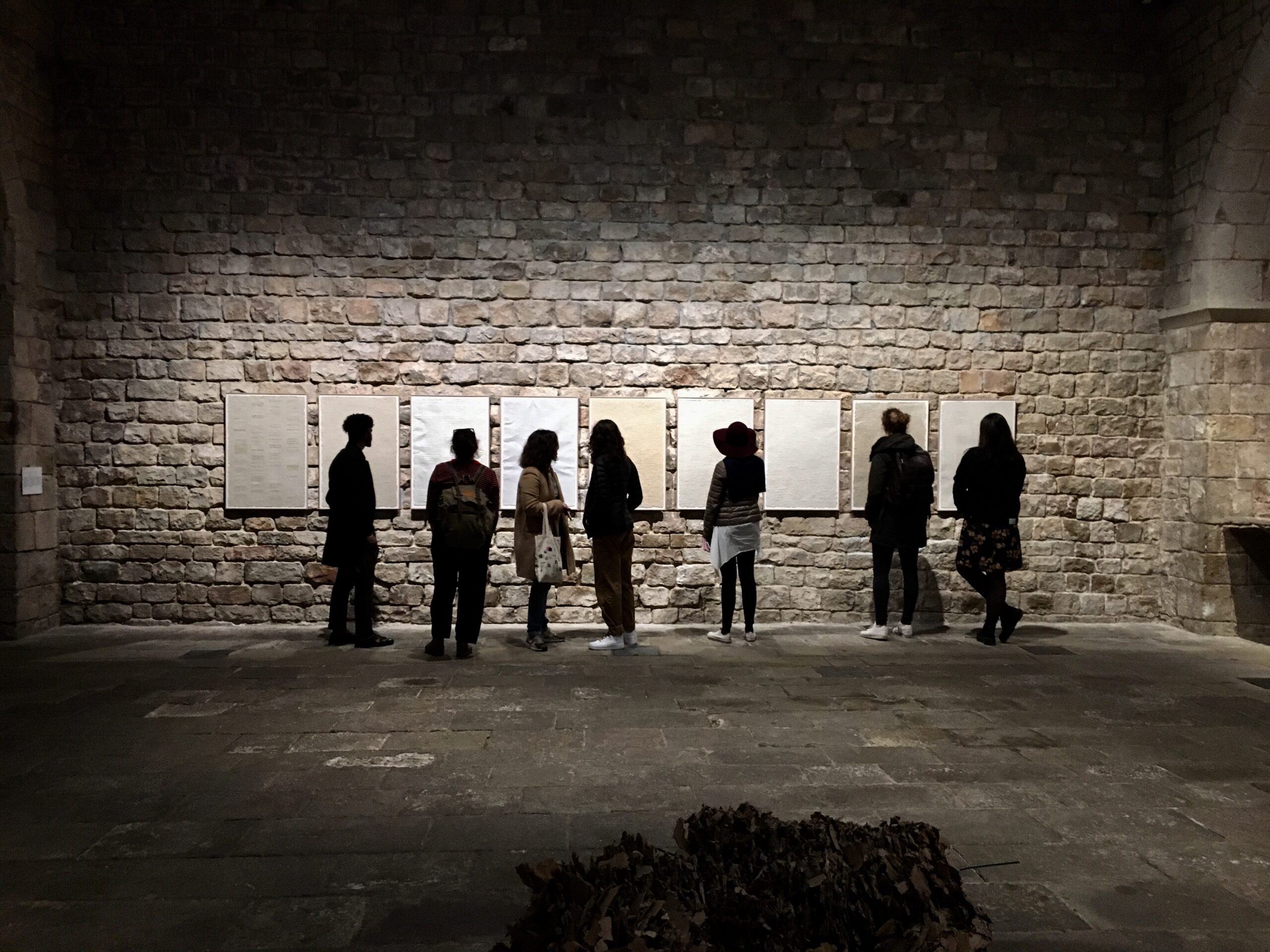 Small group admiring artwork on a private art tour in a Barcelona gallery